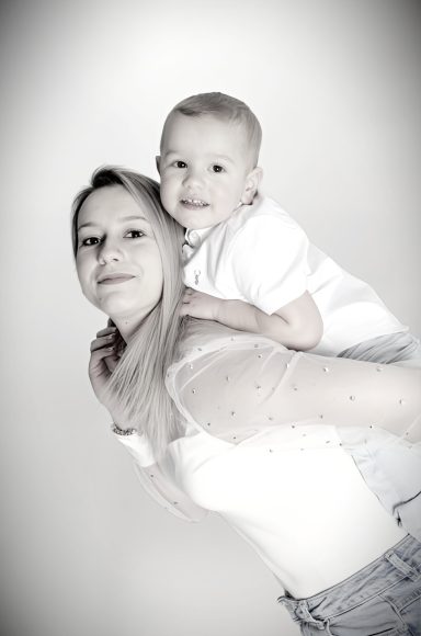 Mother and son on shoulders, family photoshoot.