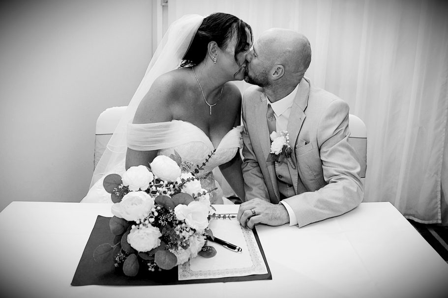 First Kiss, Signing the register wedding photography The Village Hotel Dudley Photographed by Wolverhampton wedding photographer Sarah