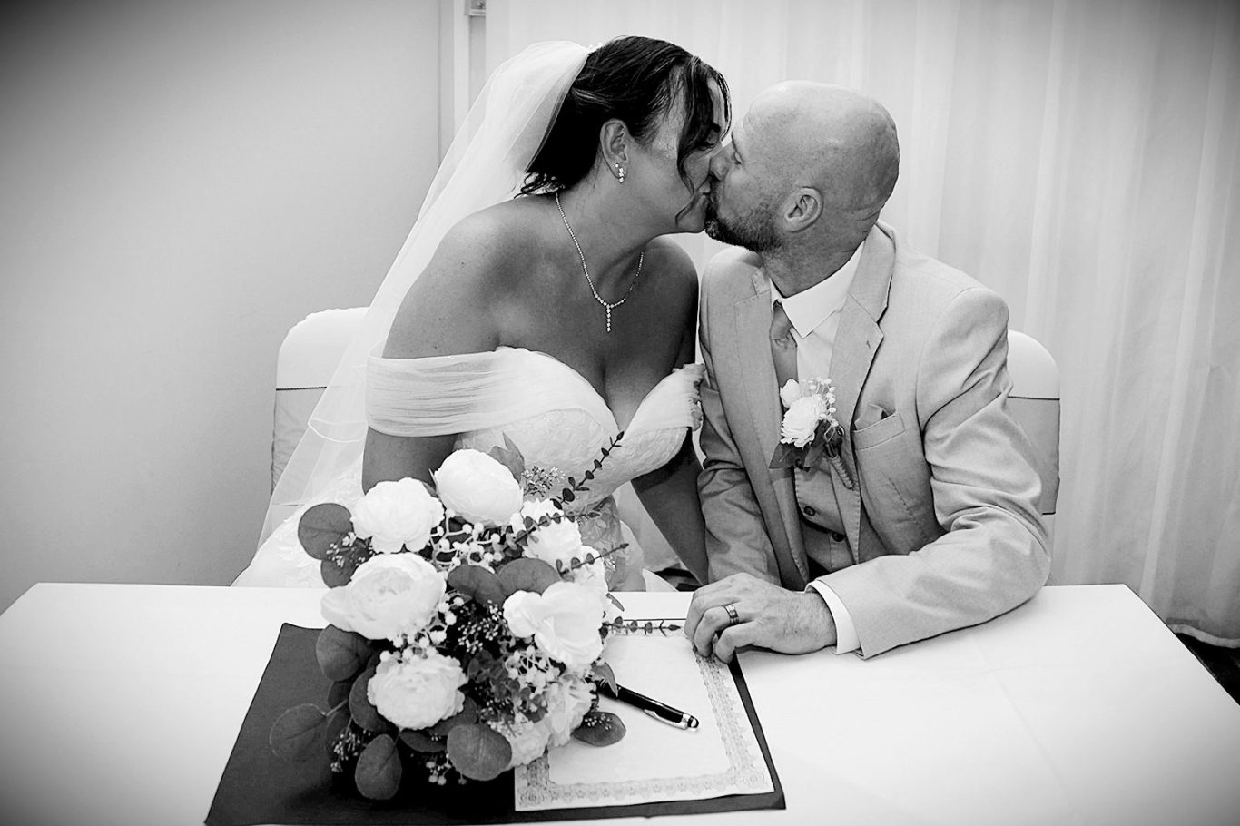 Bride & groom signing the register The Village Hotel Dudley