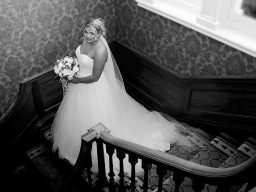 Bride standing on stairs at Brockencote Hall Hotel Photographed by Bilston photographer Sarah Ratcliffe